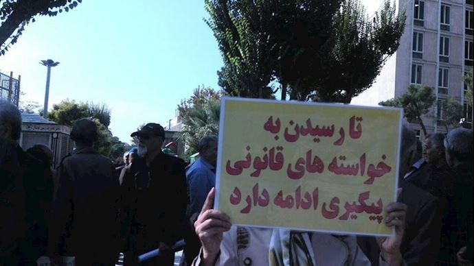Sign reads: “We will continue our efforts until our legal demands are met”