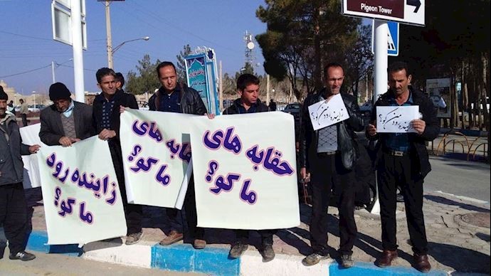 Protesting farmers holding banners that read: What happened to our right to water