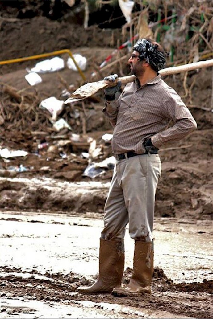 A man in Pol Dokhtar standing with the most primitive tool to fight one of the most horrible floods (Lorestan Province - Western Iran) A man in Pol Dokhtar standing with the most primitive tool to fight one of the most horrible floods (Lorestan Province - Western Iran)