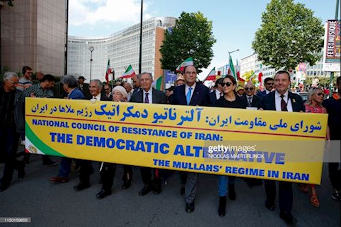 Participants holding a large poster in their organized march for a Free March. They protested Iran’s regime during their demonstration in Brussels – June 15, 2019